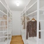 Walk-in closet of primary bedroom