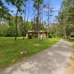 Long driveway and brick bunaglow