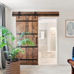 Primary bedroom with barn door to bathroom